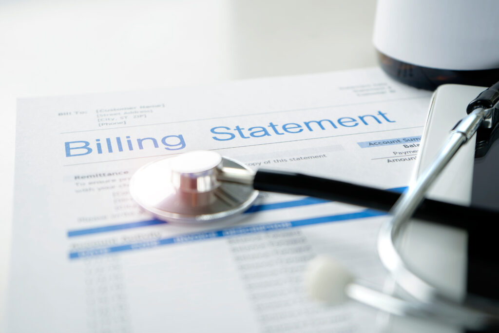 Close-up of a medical billing statement with a stethoscope, symbolizing healthcare billing processes and financial management in the medical industry.