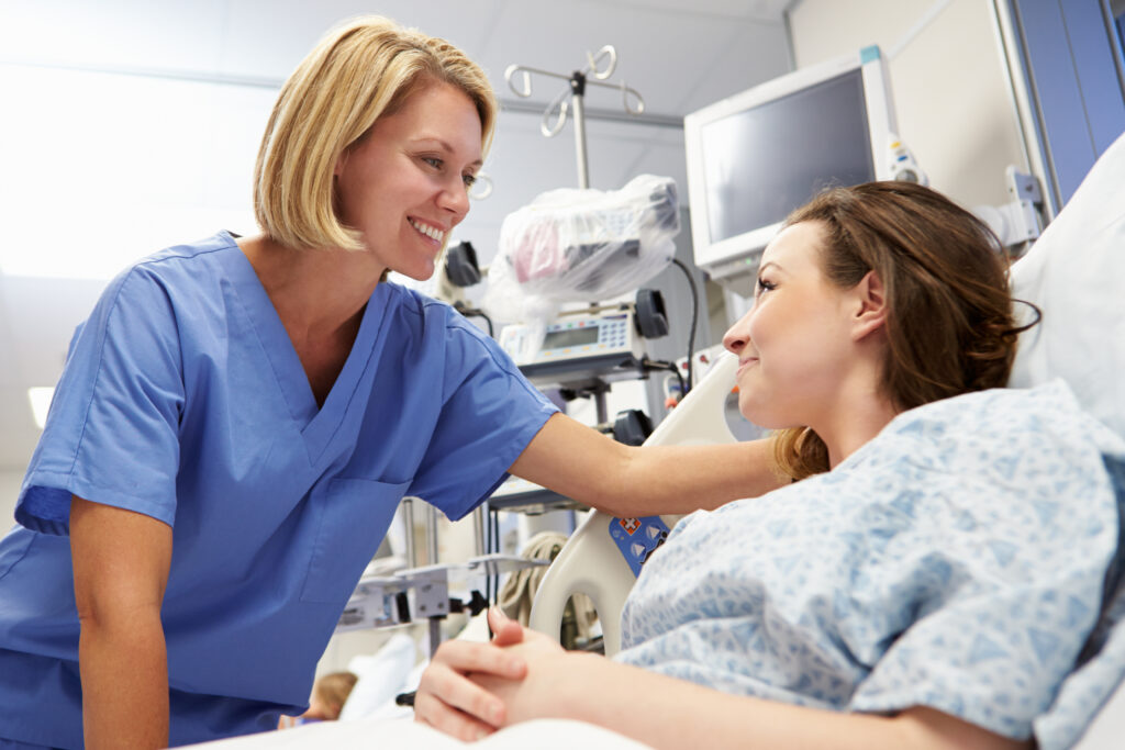 Compassionate nurse comforting a patient in a hospital room, showcasing the nurturing care provided in healthcare settings.